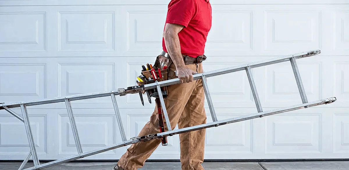 Garage door repair technician arriving with tools and ladder in Cleveland, OH