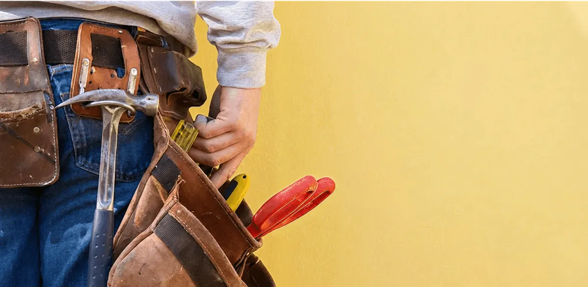 Handyman with tool belt ready for home repairs and maintenance in Cleveland, OH